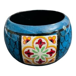 Wooden hand painted bangle. Colors of blue, red, yellow, green, and white.